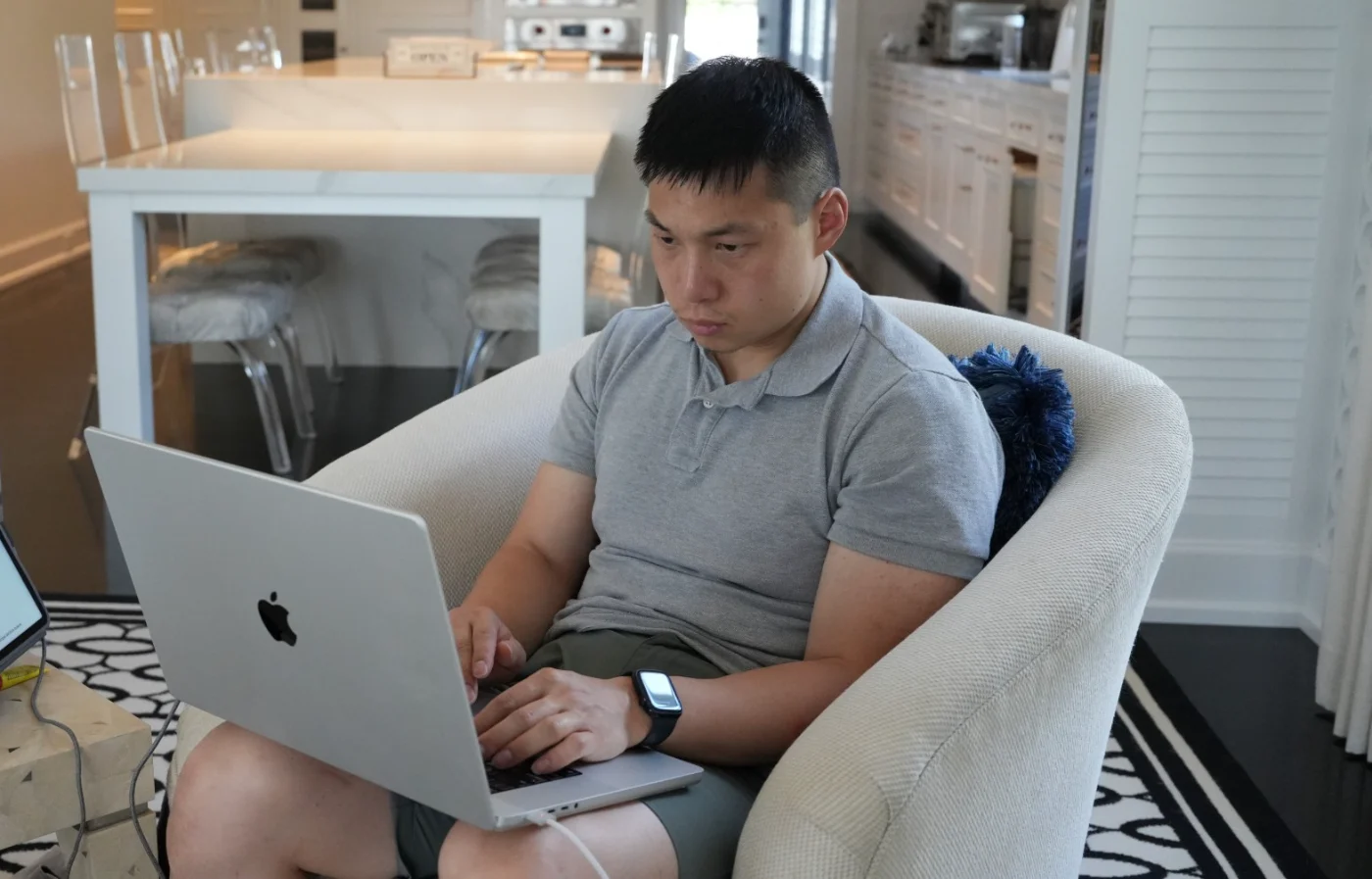 Jonathan Oh working on a laptop, with a tablet open beside him